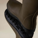 Close-up of the olive green rubber upper and rugged black treaded outsole on Le Chameau women’s wellington boots.