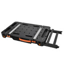 Black portable workbench with orange handle, metal rails, and extendable legs. The design appears modular and functional, conveying versatility.