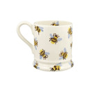 A side view of a white ceramic mug featuring a repeating bee pattern with blue wings and yellow bodies, shown against a plain white background.