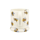 The back view of the white ceramic bee mug, highlighting the handle and the all-over bee design.