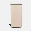 A side view of a cream predal bin on a white background