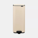A front view of a cream predal bin on a white background