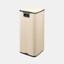 A back view of a cream predal bin on a white background