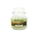 Price’s Candles Calming Green Tea small jar candle with light green wax and clear glass lid, featuring a label depicting a tranquil green tea plantation at sunrise, evoking a soothing and refreshing fragrance.