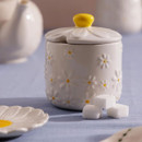 Price & Kensington Daisy sugar bowl with lid and spoon notch, displayed on a pastel breakfast table alongside sugar cubes.