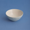 Price & Kensington Daisy embossed bowl shown against a blue background, highlighting its delicate daisy border pattern.