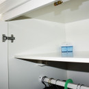 Kontrol moisture trap stored inside a white wardrobe to protect clothing and fabrics from damp and odours.