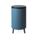 Slate blue bathroom bin with a sleek cylindrical design, black lid, and three short matching legs for a modern elevated look.