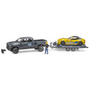 A toy model set features a gray pickup truck, a yellow race car on a trailer, and a figurine in a helmet. The scene suggests a racing theme.