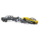 Toy set with a gray pickup truck towing a trailer carrying a yellow sports car. A figurine stands beside the truck, giving a dynamic, playful feel.