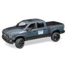 A grey toy pickup truck with black accents, large tires, and "racing team" decals. The truck has a rugged, sporty design and an open bed.