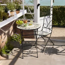 A view of a folding mosaic design bistro garden furniture set on a patio