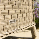 A close-up of the Kettler brand plaque fixed to the woven rattan frame of the Charlbury outdoor furniture set.