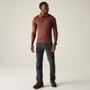 A front view of a man wearing a brown Regatta polo shirt on a white background