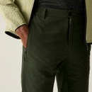 A close up front view of a man wearing  pair of khaki green Regatta walking shorts on a white background