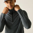 A close up front view of a man wearing a grey half zip Regatta fleece on a white background
