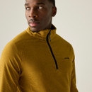 A close up view of a man wearing a brown Regatta half zip fleece on a white background