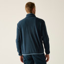 A back view of a man wearing a navy full zip fleece on a white background