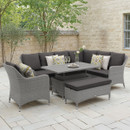 A modern outdoor seating area featuring a grey wicker sectional sofa with dark cushions, decorative pillows, and a rectangular table.