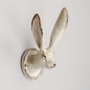 A textured white rabbit head wall hook with long ears, featuring a distressed finish for a vintage look, mounted on a plain light background.