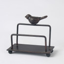 A small, rustic metal holder with a bird figurine perched on top. The design is minimalist yet elegant, on a simple base with rounded feet.