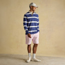 A front view of a man wearing a blue and white striped Joules rugby shirt