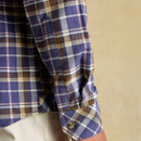 A close up view of the sleeves on a navy and pink flannel Joules long sleeve shirt