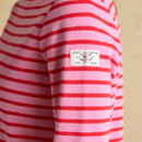 Close-up of the sleeve badge on a pink long-sleeve top with red Breton stripes, featuring the Joules branded patch.