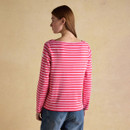 Back view of a pink Breton-stripe long-sleeve top with red horizontal stripes, worn with blue jeans.