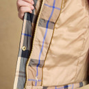 Close-up of the jacket’s inner zip panel and smooth printed lining in soft beige tones.