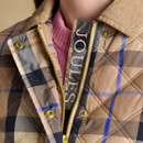 Detailed view of the jacket’s internal placket featuring the Joules logo embroidery alongside the gold zip.