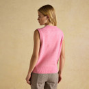 Back view of a bright pink sleeveless knitted vest worn by a woman, showing its clean shape and ribbed hem.