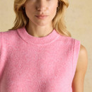 Close-up of the neckline and upper section of a bright pink sleeveless knitted vest, highlighting the soft textured knit.