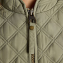 Detail of the metal zip pull on an olive green quilted gilet, highlighting the branded hardware and stitched finish.