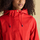 Close-up of the hood on a bright red raincoat, showing drawcords with contrasting tips.