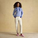Full-length outfit featuring a blue and white striped hoodie paired with cream trousers and pink trainers.