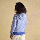 Back view of a women’s blue and white striped hoodie featuring a relaxed hood and ribbed blue hem.