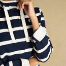 Detail of the cuff and sleeve placket on a navy and white striped women’s sweatshirt.