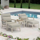Two mocha coloured reclining chairs with one reclined, with matching footstools and a side table, arranged on a patio beside a swimming pool.