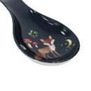 A close up view of a navy woodland animal spoon rest on a white background