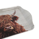 A close up view of a highland cow trinket tray on a white background