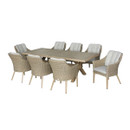 A dining table with six rattan chairs surrounding it, against a white background.