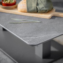 Close-up of anthracite square outdoor side table with a grey tabletop, showing rounded corner detail and tabletop texture.