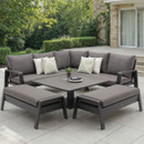 Anthracite garden corner lounge dining set with two benches and a lowered height-adjustable square table on a patio.