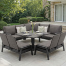 Anthracite garden corner lounge dining set with two benches with back rests and a raised height-adjustable square table on a patio.