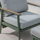 Close-up of sage green reclining armchair with eco mist seat and back cushions, showing the wooden-look armrest detail.