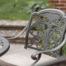 Close-up of a bronze dining chair backrest.
