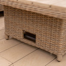 Detail shot of the woven rattan table base with an open recess and short round legs on a timber decking surface.