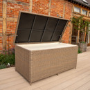Outdoor rattan storage box with the hinged lid open, revealing a spacious waterproof interior on a garden deck.