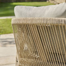 Detail of rope weave on the back of a wooden outdoor garden chair with grey cushion.
